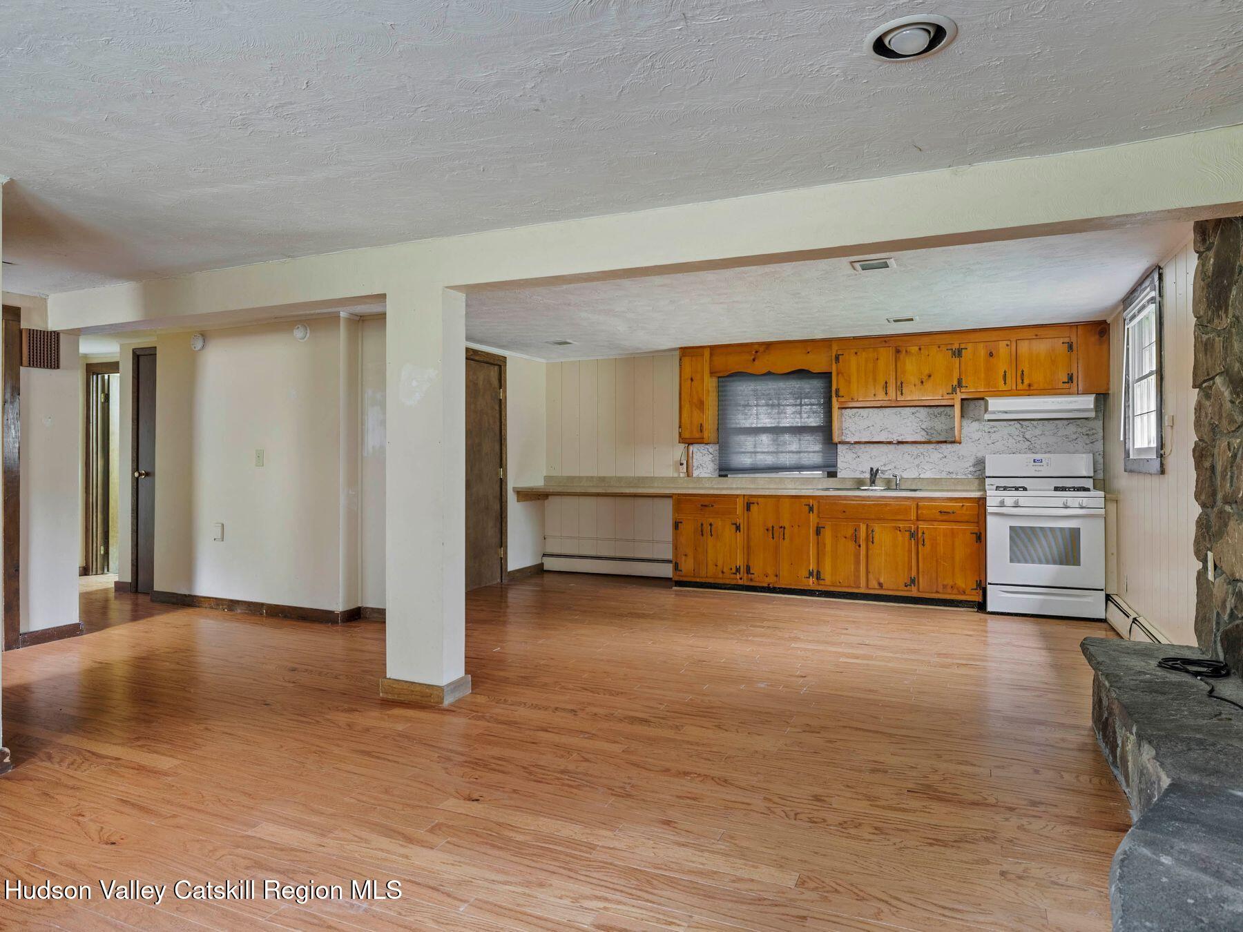 317 Mitchell Hollow Road Windham, NY 12496 - Photo 7 of 41 a view of a livingroom with furniture and a kitchen