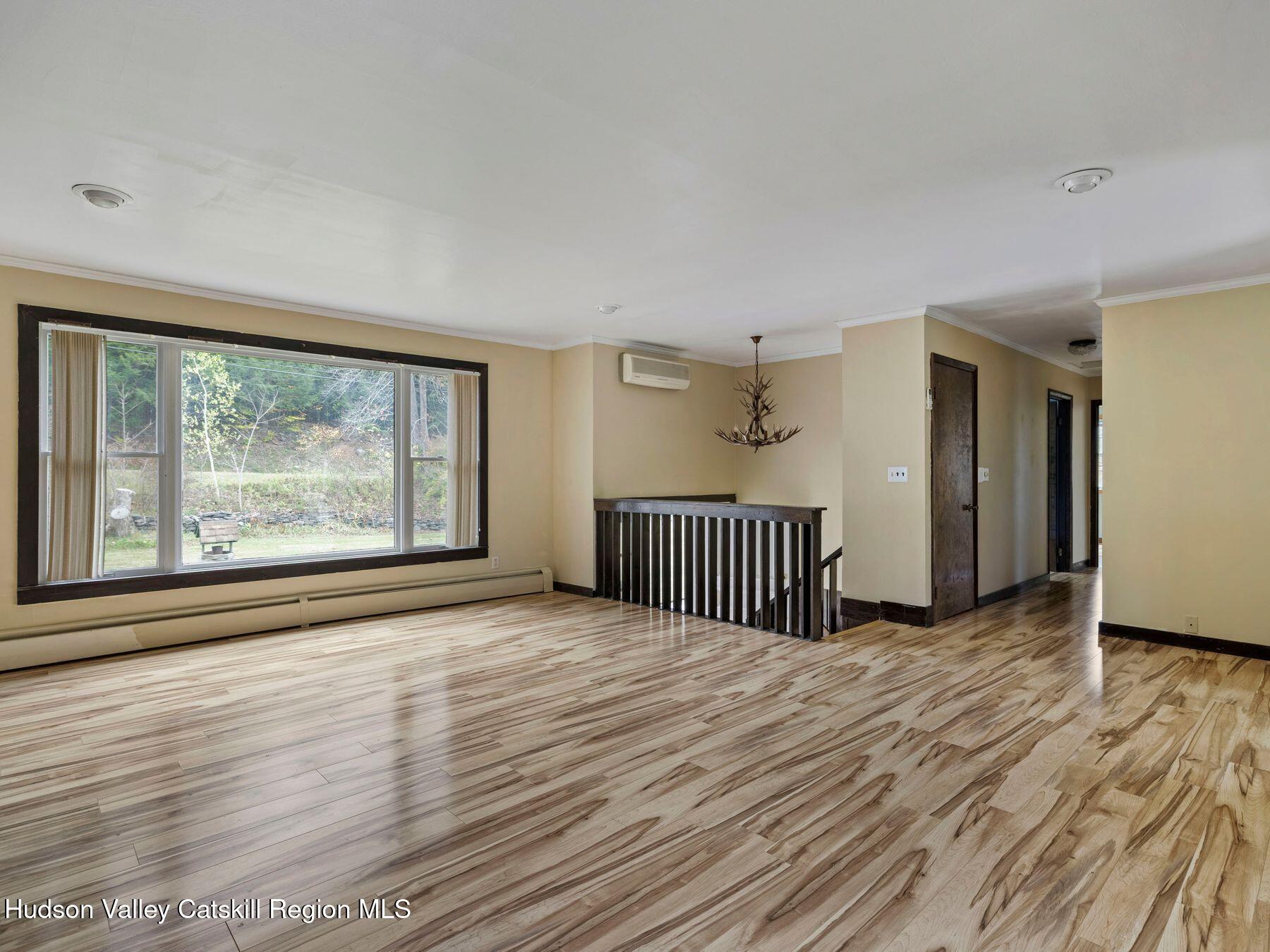 317 Mitchell Hollow Road Windham, NY 12496 - Photo 10 of 41 an empty room with wooden floor and windows