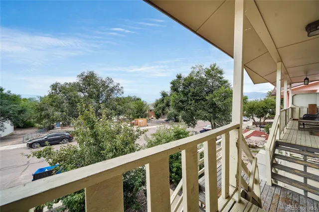 a view of a balcony with wooden floor