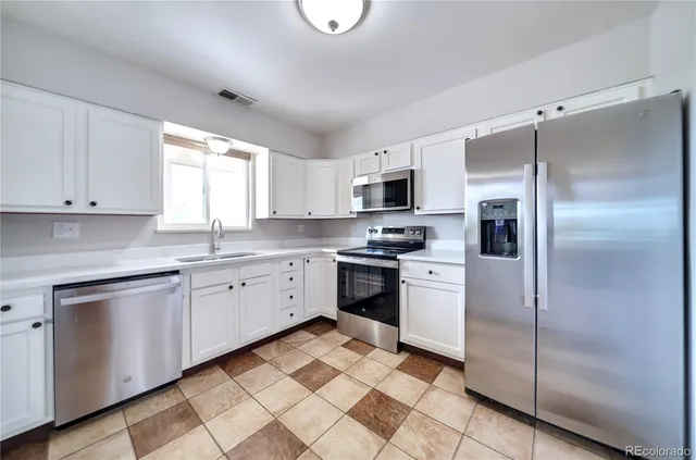 a kitchen with a refrigerator sink and microwave