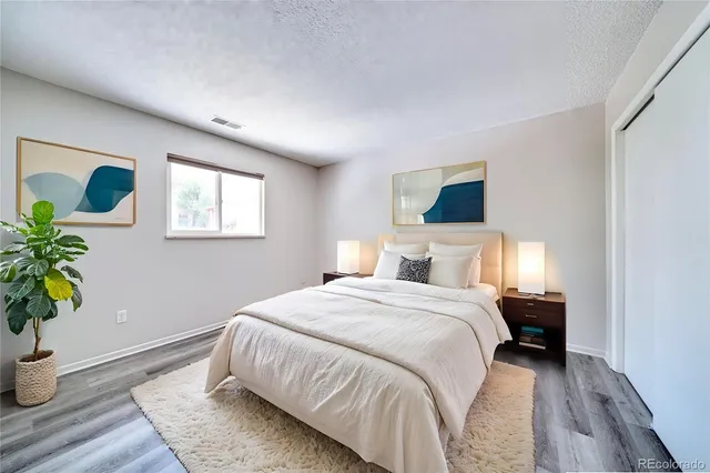 a bedroom with a bed and a potted plant