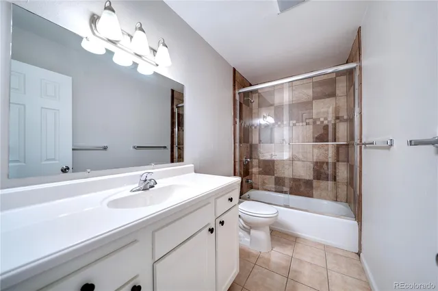 a bathroom with a double vanity sink mirror and toilet