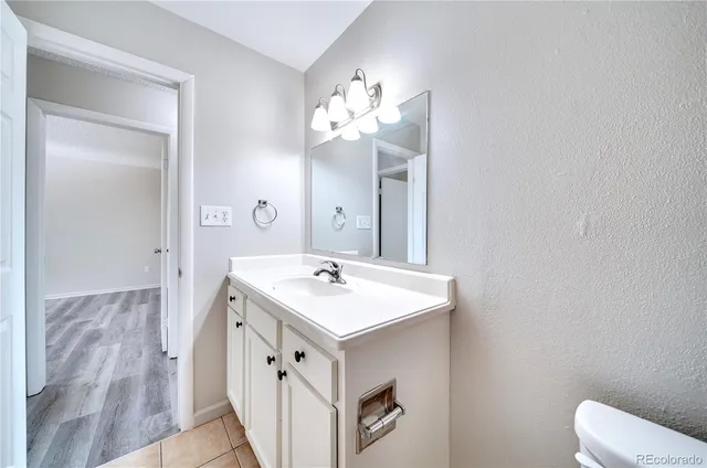 a bathroom with a sink vanity and a mirror