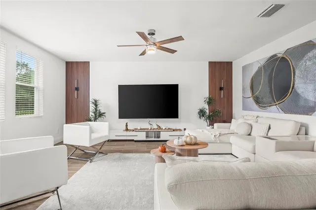 a living room with furniture and a flat screen tv