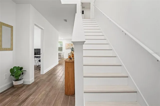a view of entryway and hall with wooden floor