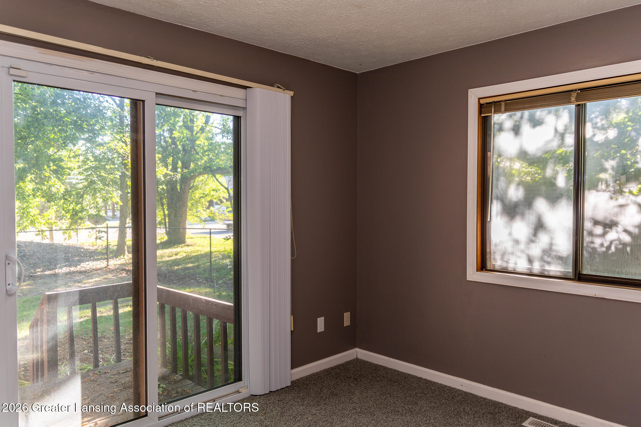101 East Jolly Road, Unit B8 24 Lansing, MI 48910 - Photo 19 of 43 Bedroom #2- Sliding door leading to deck