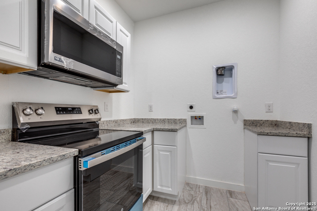 5415 Ingram Road, Unit 1209 San Antonio, TX 78228 - Photo 7 of 10 a kitchen with stainless steel appliances granite countertop a stove and a microwave