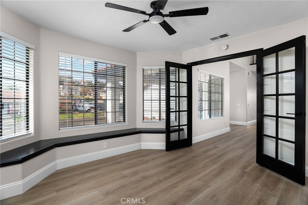 29566 Big Range Road, Unit 1 Canyon Lake, CA 92587 - Photo 14 of 55 a view of empty room with wooden floor and fan