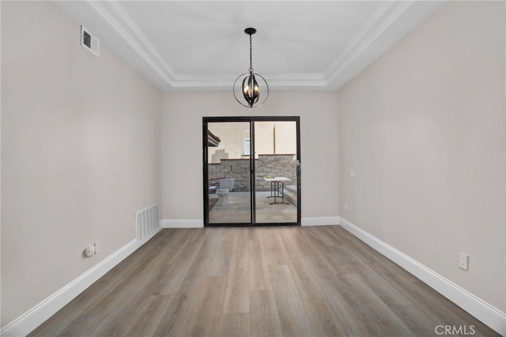 29566 Big Range Road, Unit 1 Canyon Lake, CA 92587 - Photo 15 of 55 wooden floor in an empty room with a window
