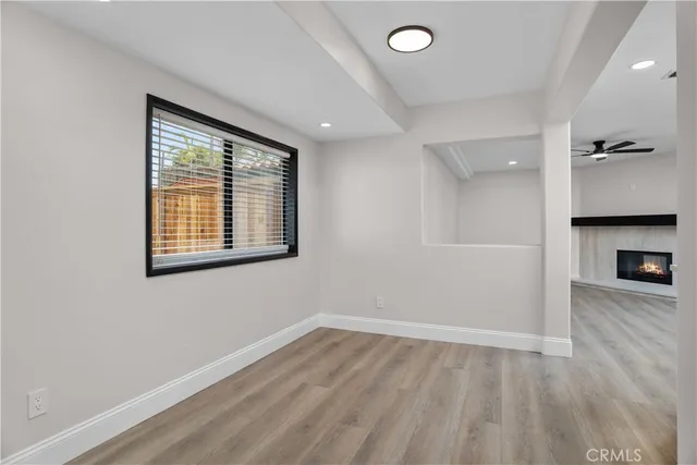 wooden floor in an empty room with a window
