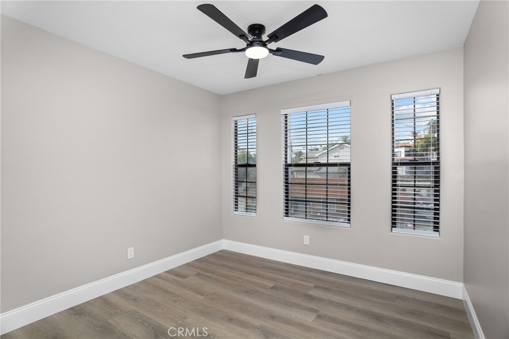 29566 Big Range Road, Unit 1 Canyon Lake, CA 92587 - Photo 27 of 55 a view of an empty room with a window and wooden floor