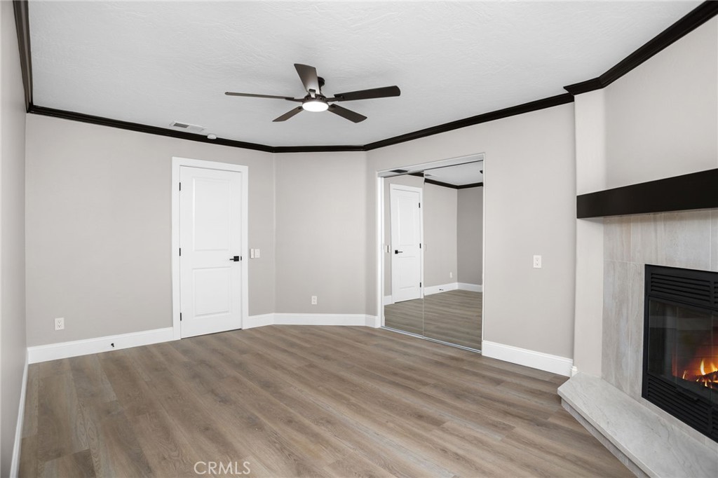 29566 Big Range Road, Unit 1 Canyon Lake, CA 92587 - Photo 34 of 55 a view of empty room with wooden floor and fan