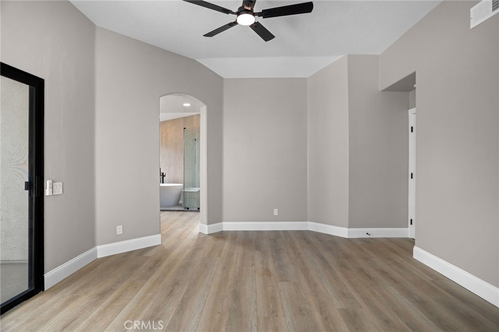 29566 Big Range Road, Unit 1 Canyon Lake, CA 92587 - Photo 36 of 55 a view of a room with wooden floor and white walls