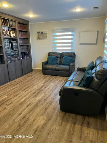 a living room with furniture and a book shelf