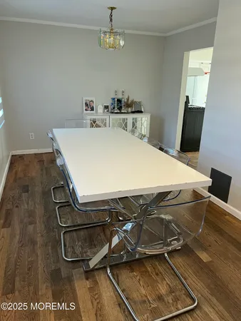 a room with a table chairs and a ceiling fan