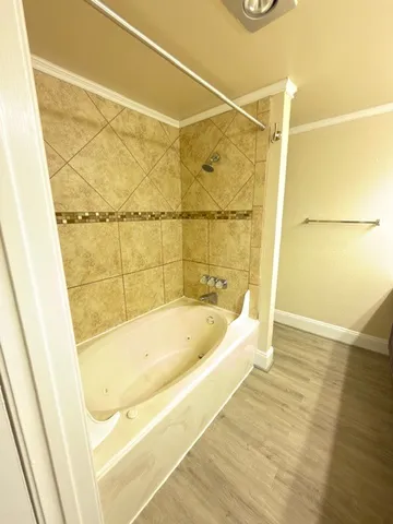 a bathroom with a bathtub and shower