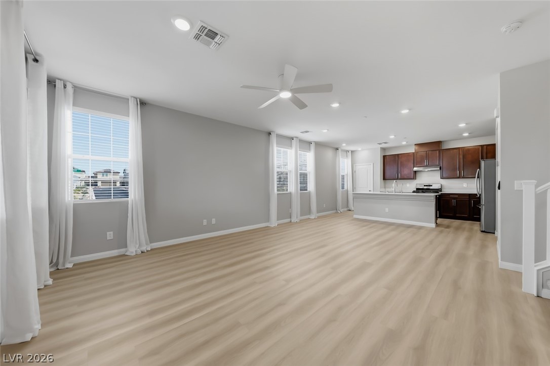 3564 Credere Lane Henderson, NV 89074 - Photo 6 of 40 Unfurnished living room with ceiling fan, light wood-style flooring, and recessed lighting