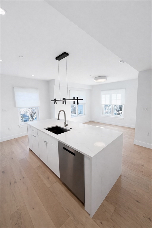 a kitchen with white cabinets and a sink