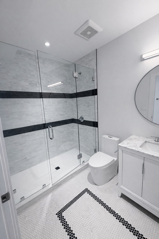 65 L Street, Unit 9 Boston, MA 02127 - Photo 5 of 8 a bathroom with a toilet sink and shower