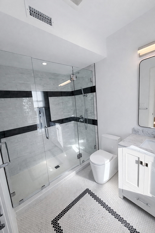 65 L Street, Unit 9 Boston, MA 02127 - Photo 8 of 8 a bathroom with a sink a toilet and a shower