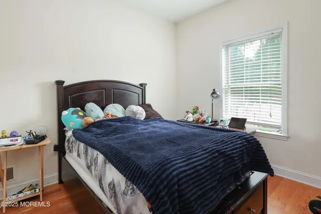 a bed sitting in a bedroom next to a window