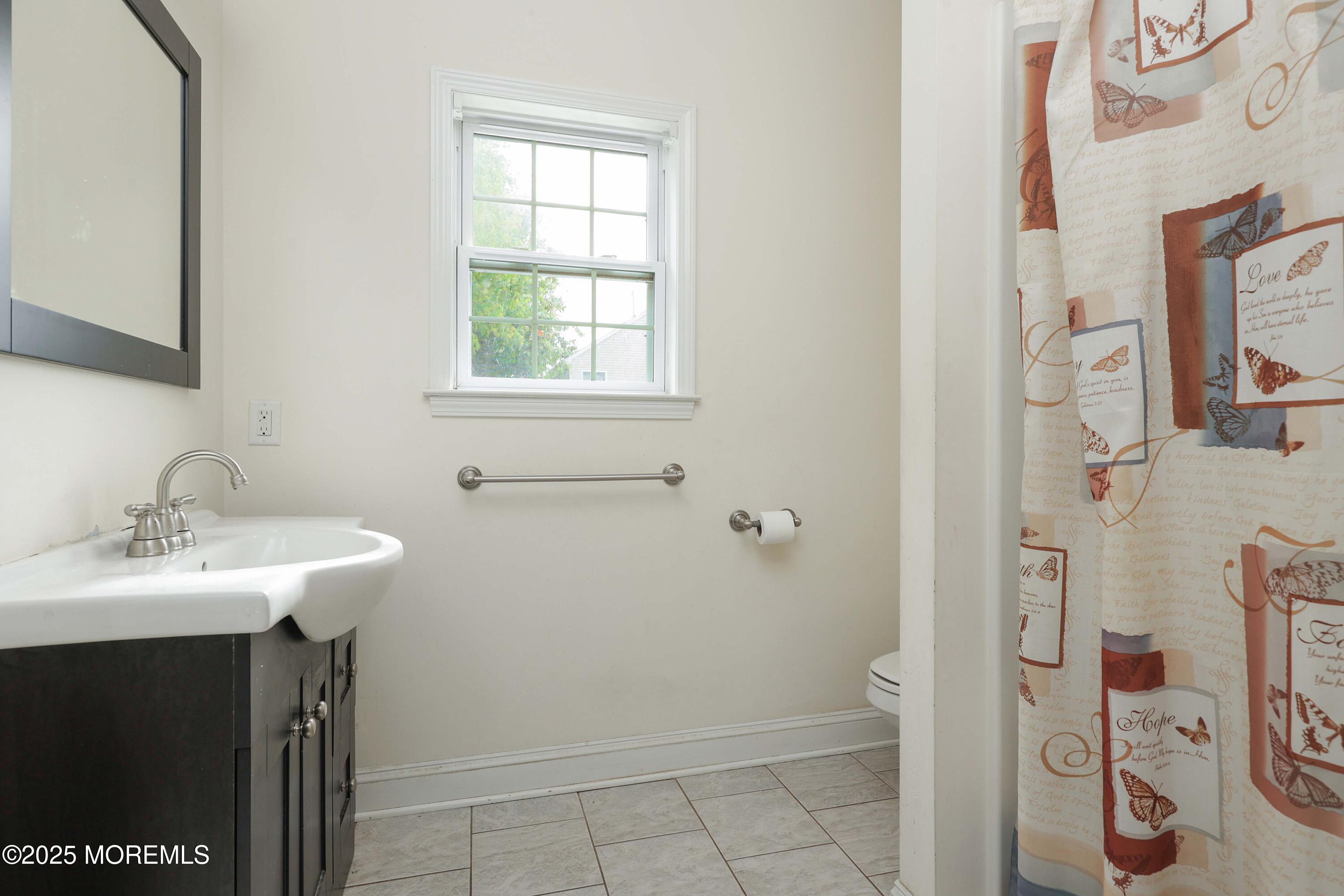 280 Linden Avenue Middletown, NJ 07748 - Photo 12 of 17 a bathroom with a sink and a mirror