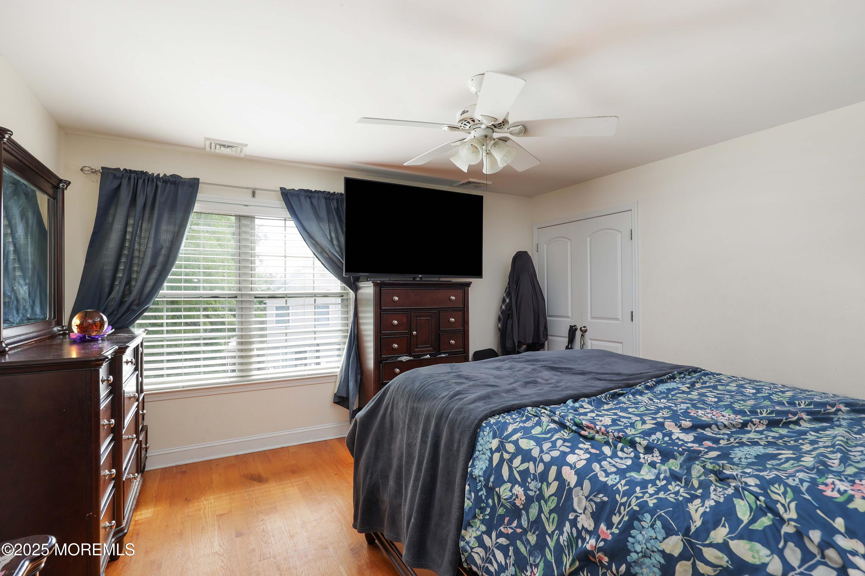 280 Linden Avenue Middletown, NJ 07748 - Photo 13 of 17 a bedroom with a bed and a flat screen tv