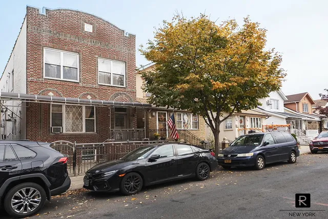 a couple of cars parked in front of a house