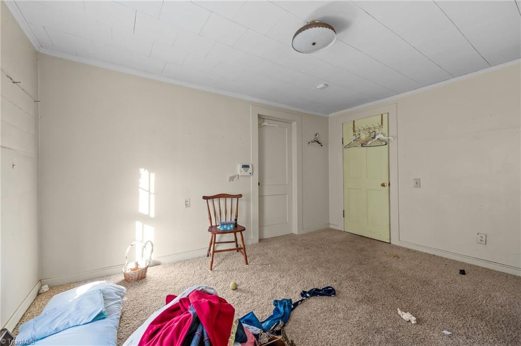 7530 Adler Road Summerfield, NC 27358 - Photo 18 of 31 2nd bedroom - the door on the left goes out to the front room. Door on the right goes into the kitchen.