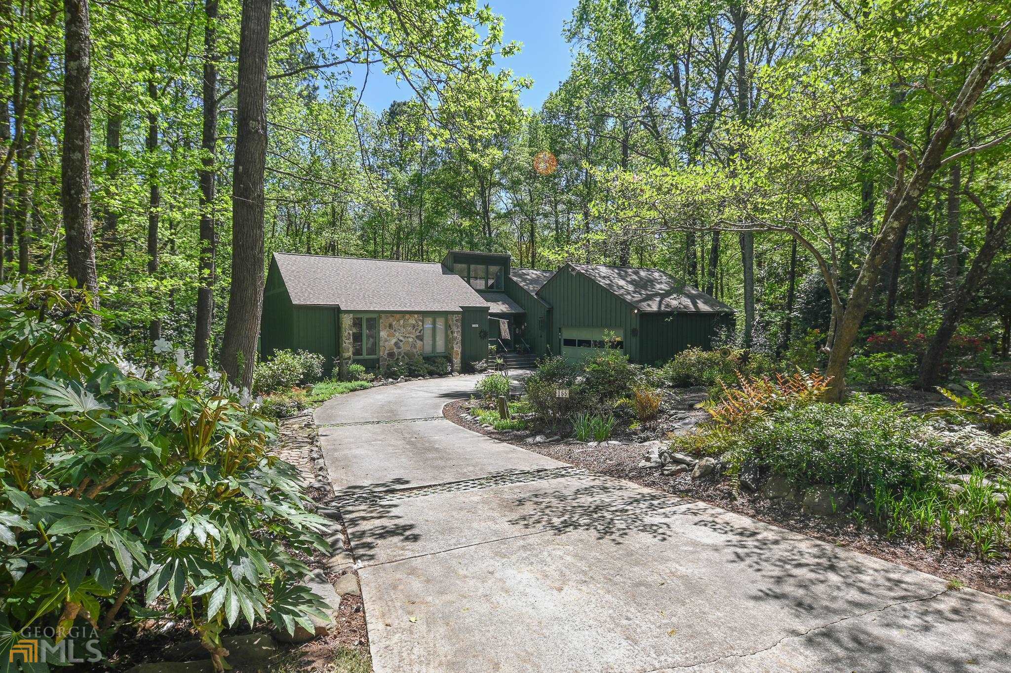155 Snapfinger Drive Athens, GA 30605 - Photo 1 of 1 a view of a garden with a table and chairs under an umbrella