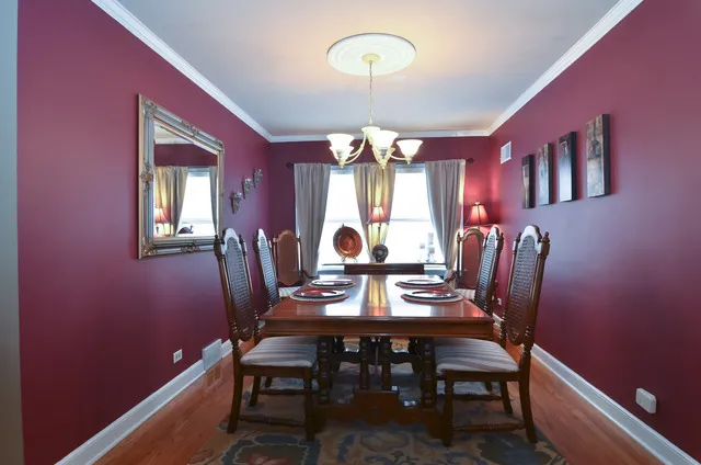 a view of a dining room with furniture and chandelier