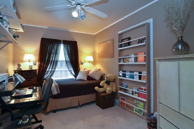 a living room with furniture and a book shelf