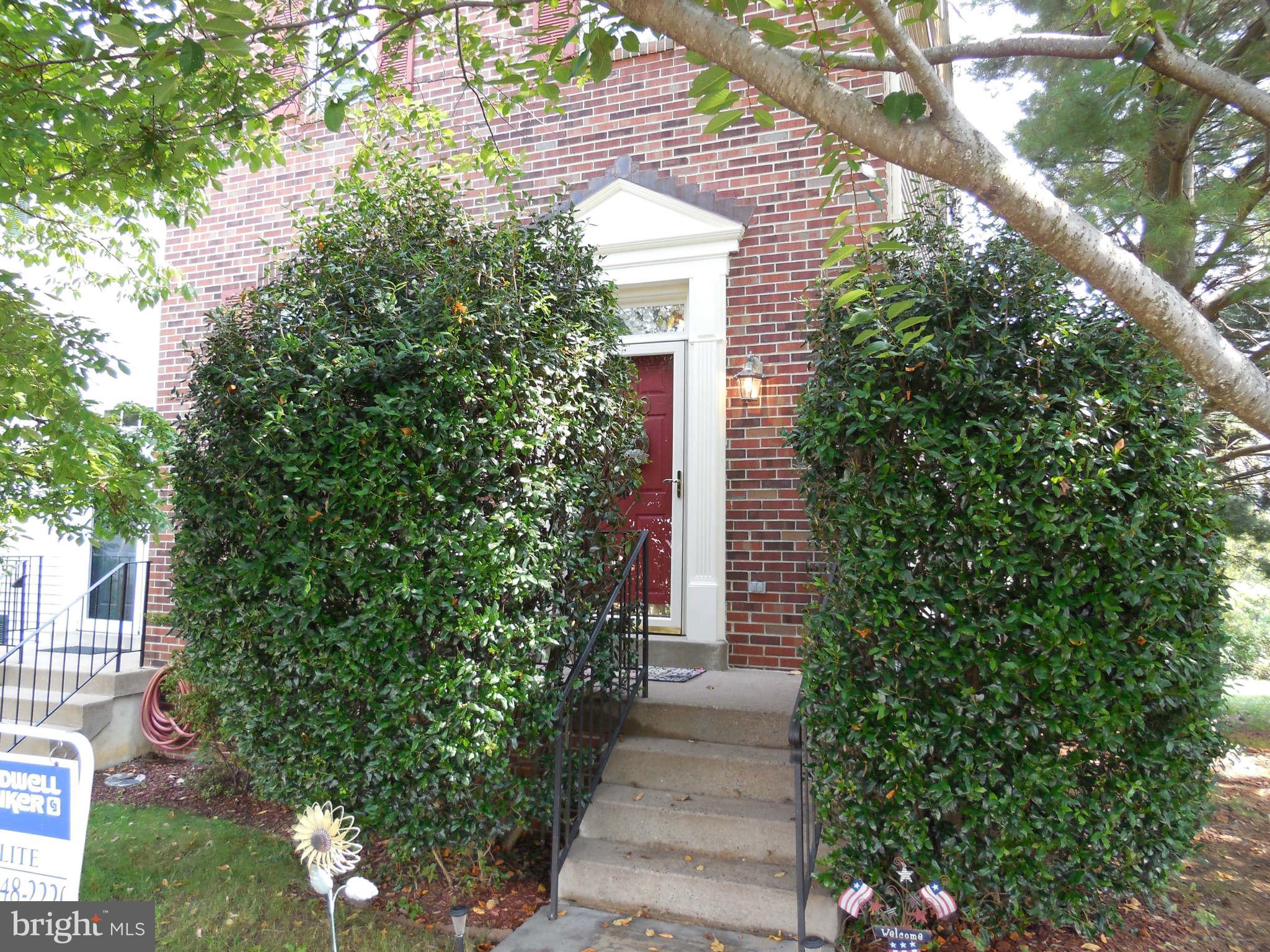 a front view of a house with trees