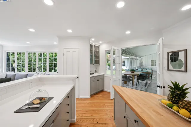 a kitchen with a sink stove and white cabinets