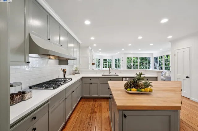 a living room with furniture and floor to ceiling windows