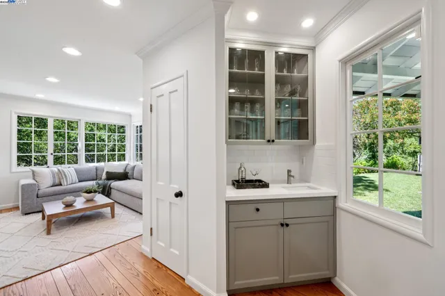 a living room with furniture fireplace and a large window