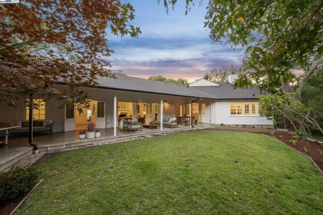 a view of a house with a yard porch and sitting area