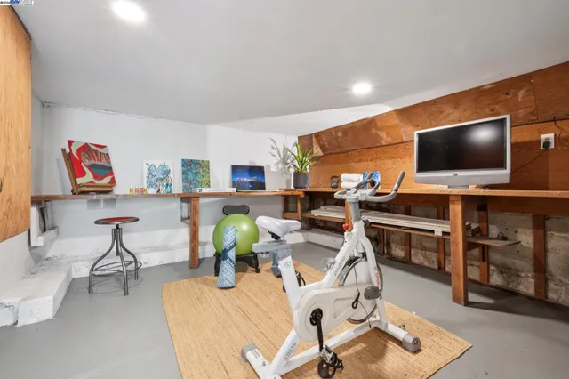 a spacious bedroom with a bed and wooden floor