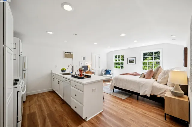 a view of a patio with table and chairs potted plants with floor to ceiling window