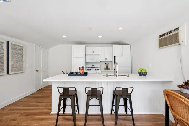 a dining room with furniture and wooden floor