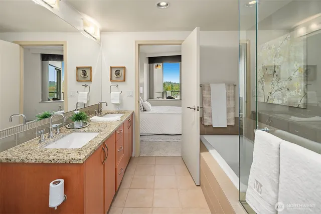 a spacious bathroom with a granite countertop tub sink and mirror