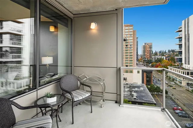 a balcony with table and chairs