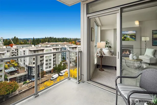 a city view from a balcony with furniture