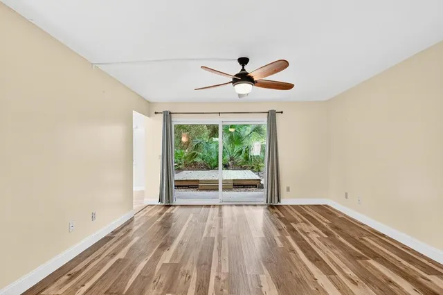 a view of a livingroom with a ceiling fan and window