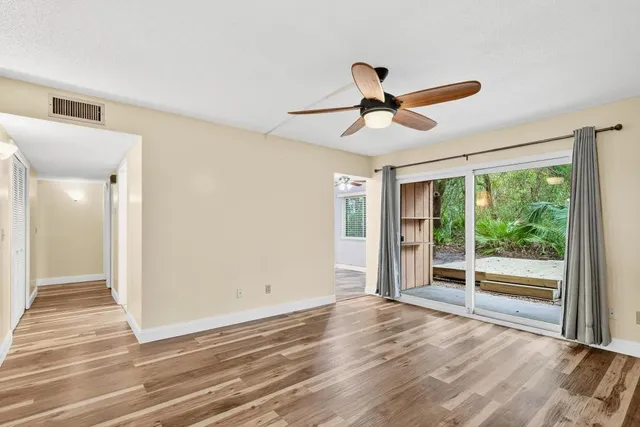 a view of empty room with wooden floor