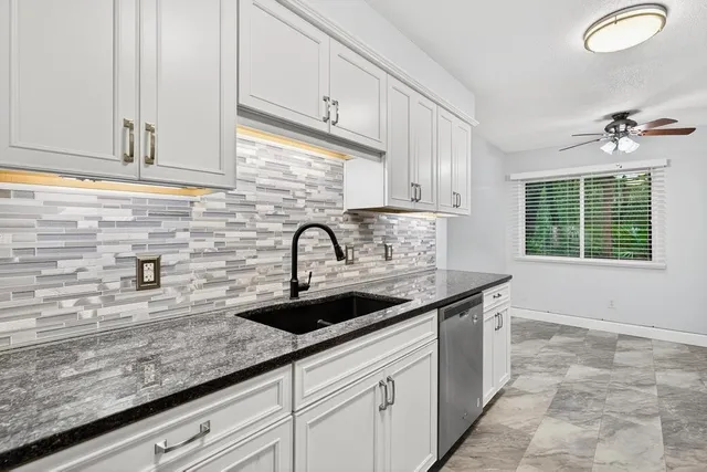 a stove top oven sitting inside of a kitchen and stainless steel appliances