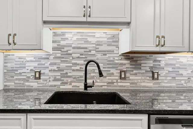 a kitchen with stainless steel appliances granite countertop a stove microwave and refrigerator