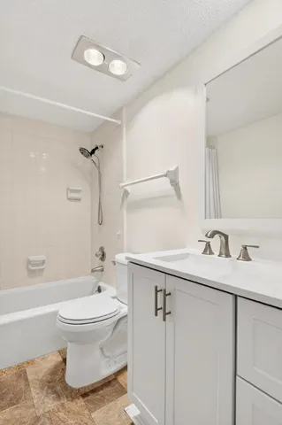a view of a room with wooden floor and a ceiling fan