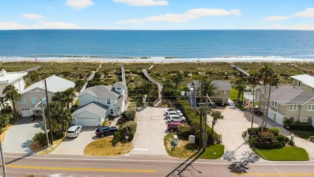 an aerial view of a house with a yard and trees
