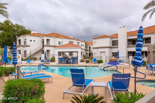 a front view of a house with swimming pool garden and patio
